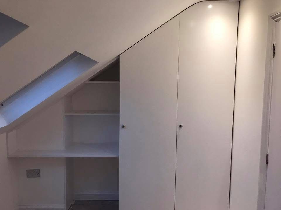 Bespoke fitted wardrobe under stairs