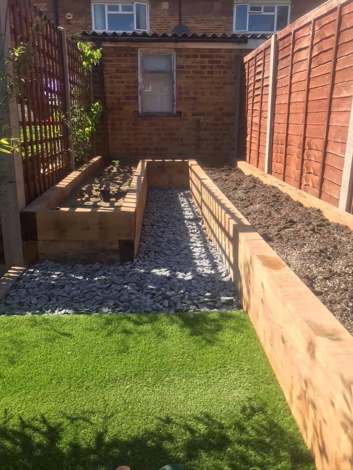 Garden with timber raised beds and slate chippings