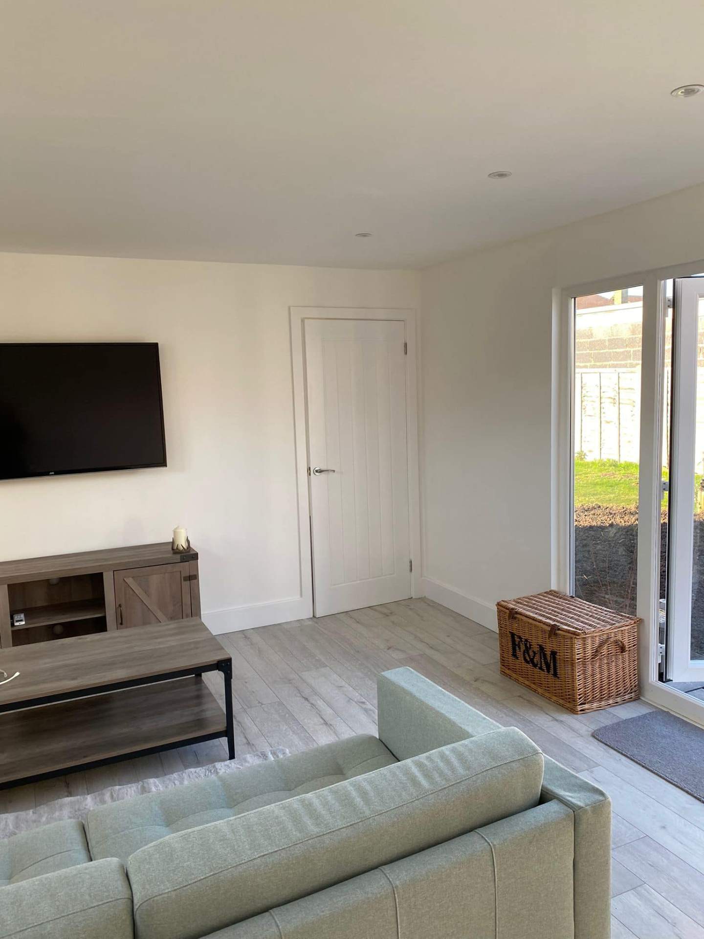 Bright living room with glass doors to garden