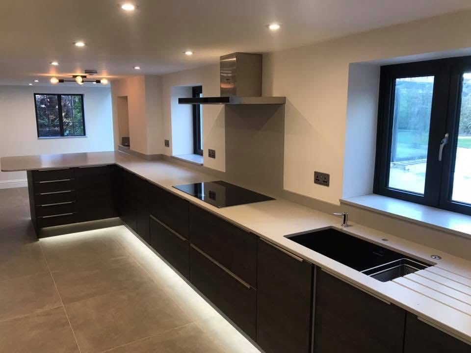 Modern kitchen with dark units and LED underlighting