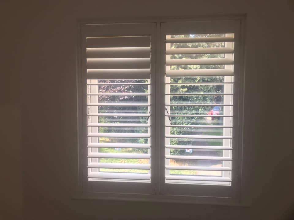 White plantation shutters fitted to window
